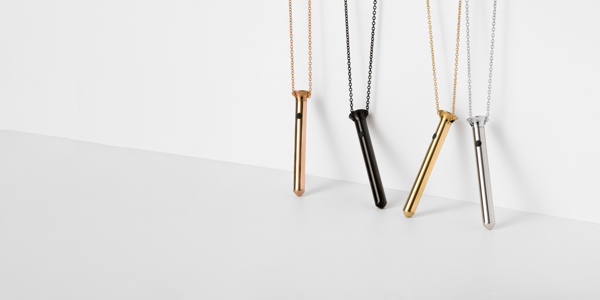 Vesper Minis in rose gold, black, 24kt gold, and silver leaning against a wall in studio lightning.