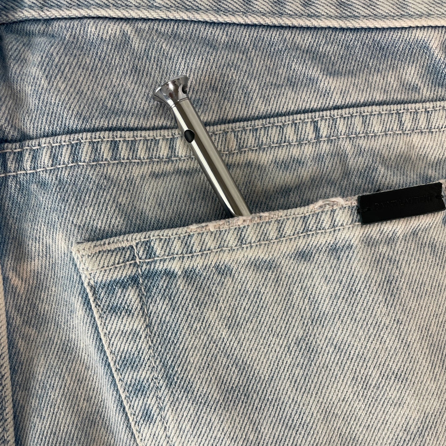 Vesper Mini tucked into the back of a jean pocket.