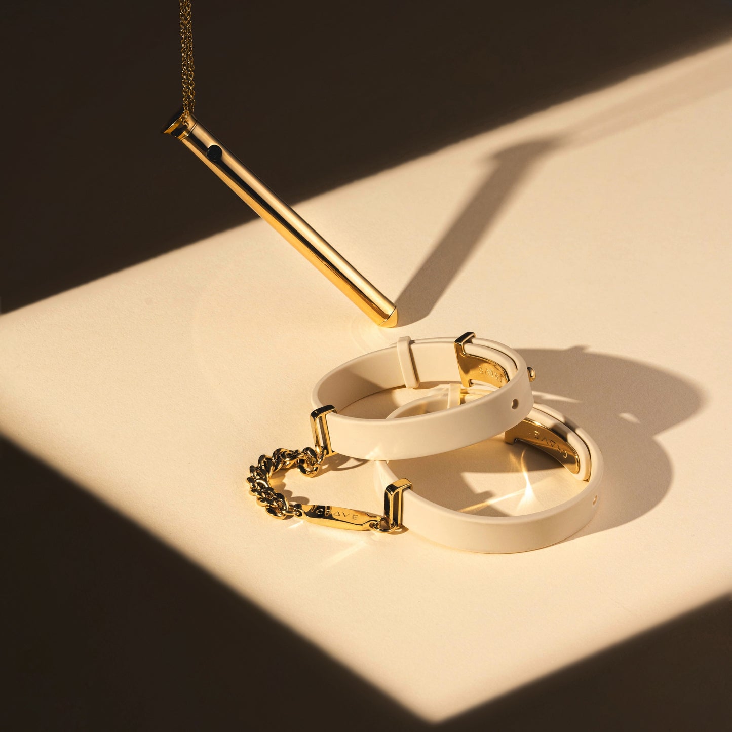 Vesper 2 in 24kt gold with ID Cuffs in beige and 24kt gold.