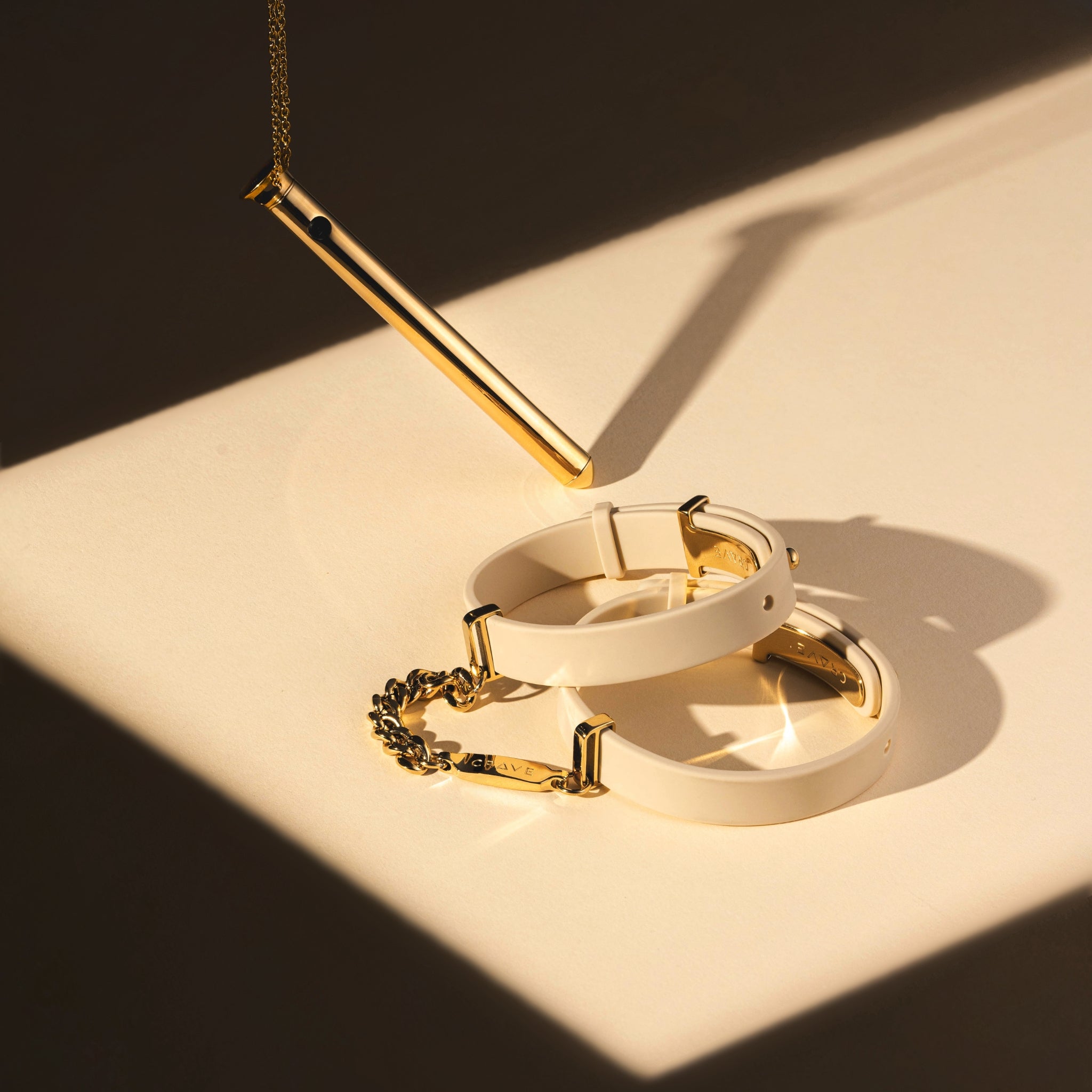 Vesper 2 in 24kt gold with ID Cuffs in beige and 24kt gold.